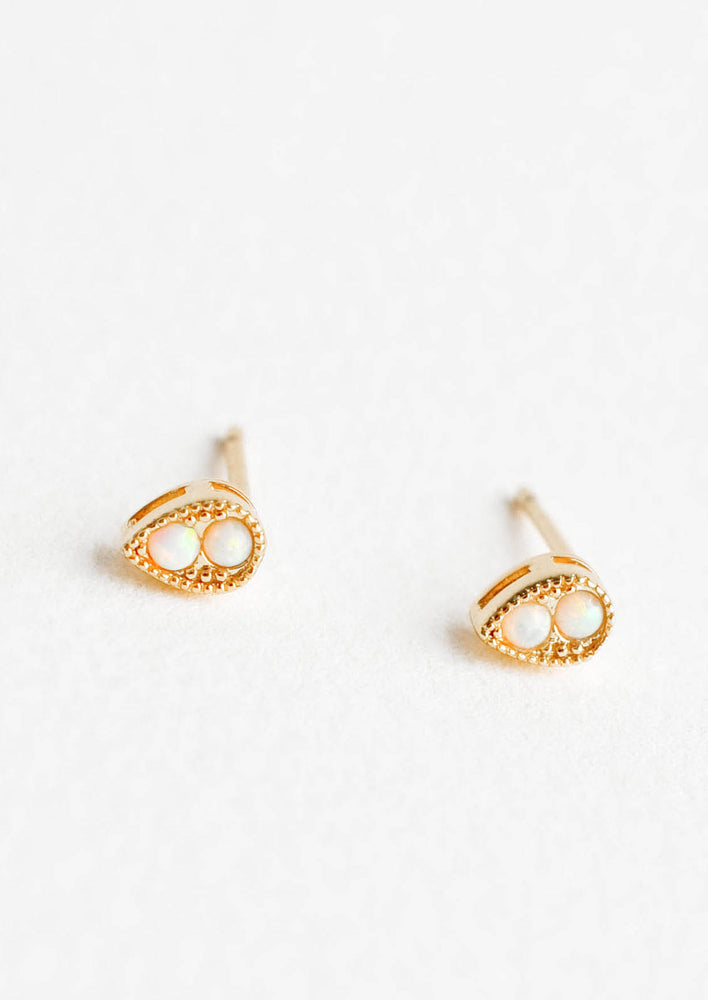 Teardrop shaped stud earrings in gold finish, with two small round opal stones inset.