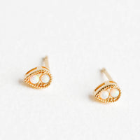 Teardrop: Teardrop shaped stud earrings in gold finish, with two small round opal stones inset.