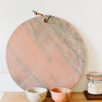 4: Pink and tan marble serving platter and prep bowls on a kitchen counter