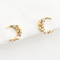 1: A pair of gold crescent moon shaped earrings with crystal and pearl detailing.