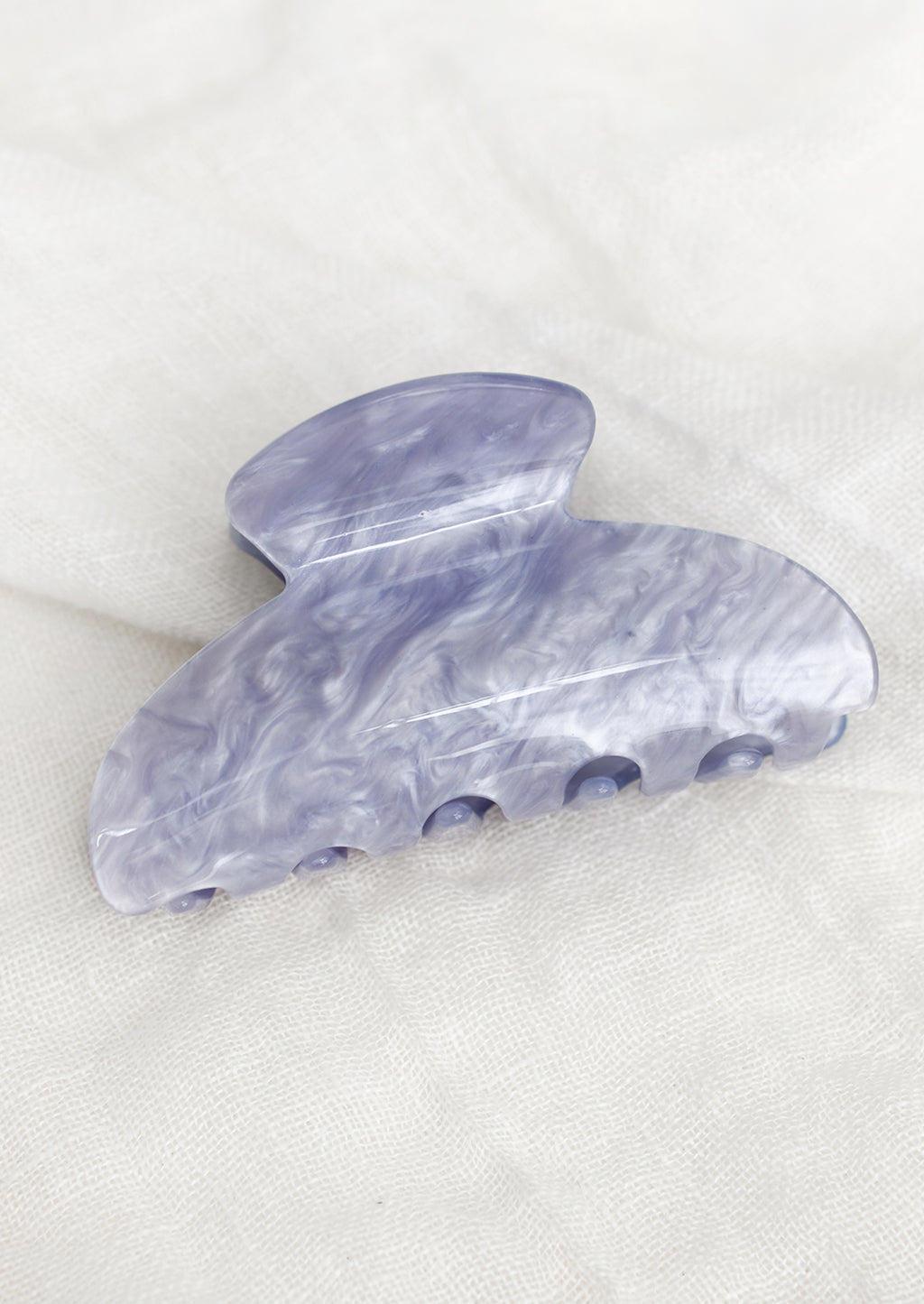 Periwinkle: A plastic hair claw in pearlized periwinkle.