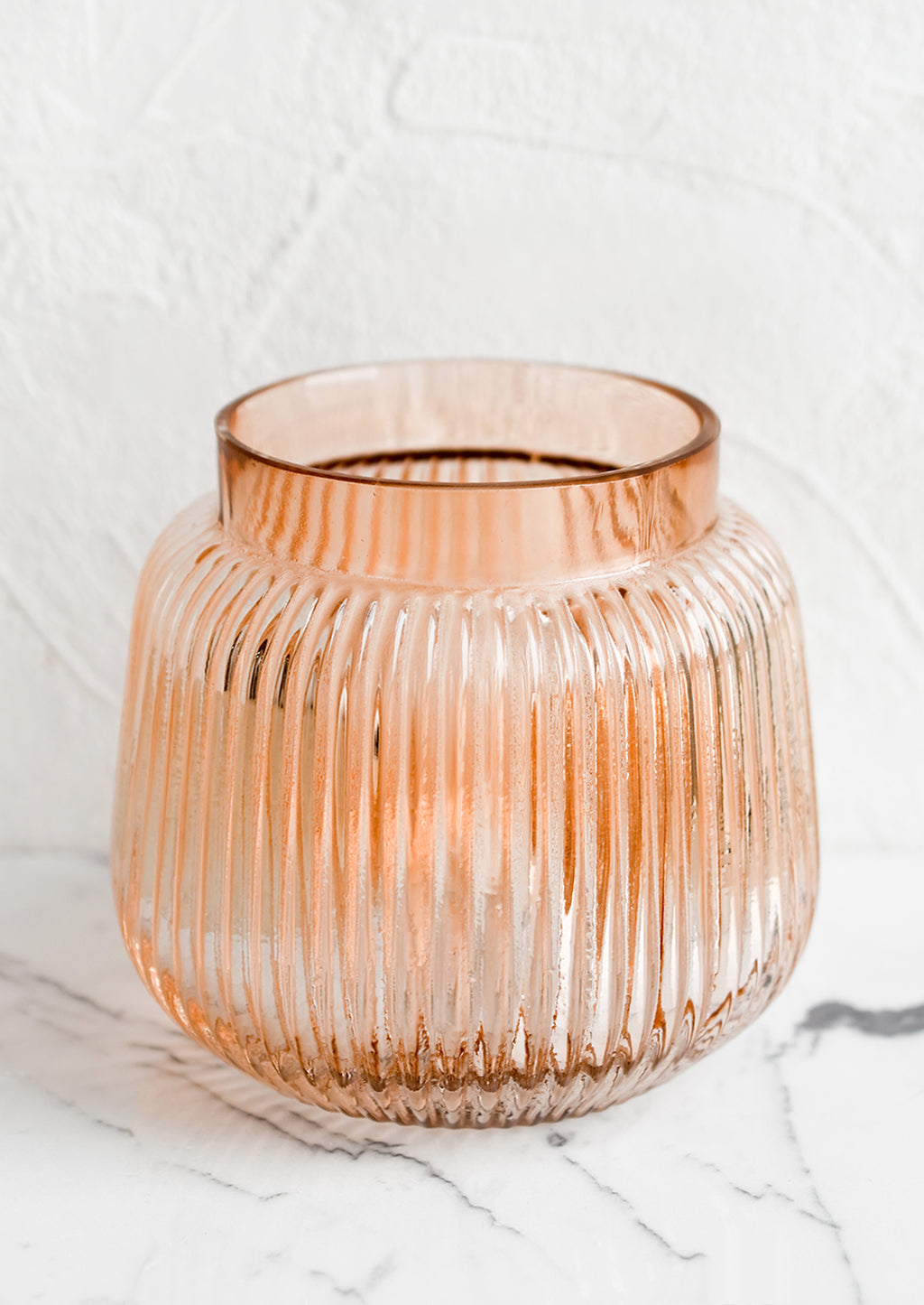 Short: A short glass vase with wide opening and ribbed texture.