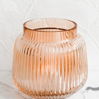 Short: A short glass vase with wide opening and ribbed texture.