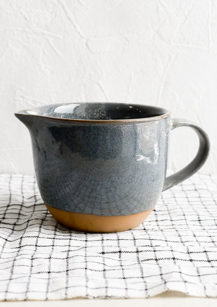 A ceramic pouring bowl in dipped dark blue glaze.