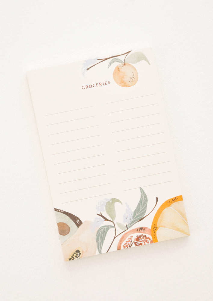 Lined notepad featuring text "Groceries" and a fruit motif.