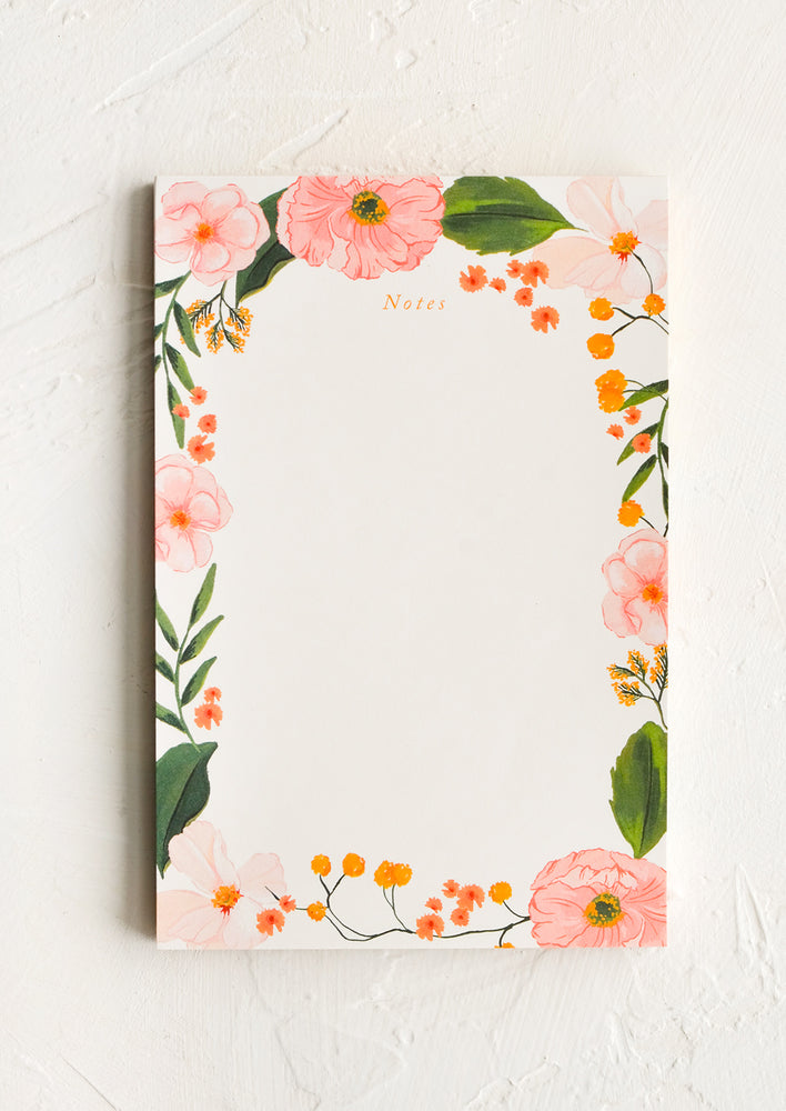 A notepad with floral border.