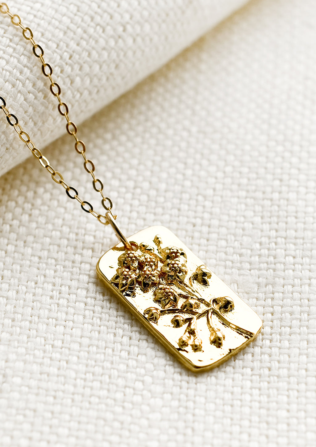 Wildflower: A tag style necklace with wildflower design.
