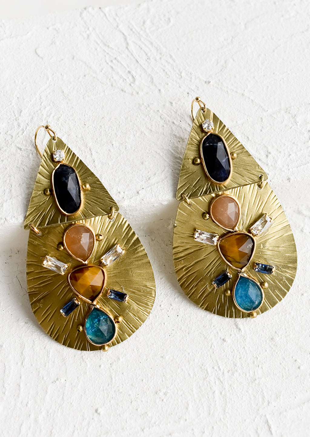 1: A pair of teardrop shaped gold metal earrings with crystal and gemstone embellishment.