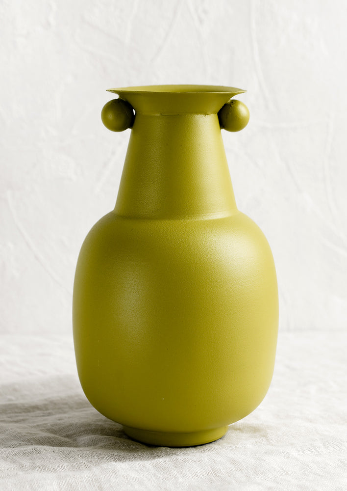 1: A lime green vase with round ball detailing at top.