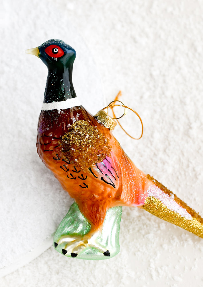 1: A holiday ornament of a pheasant bird.