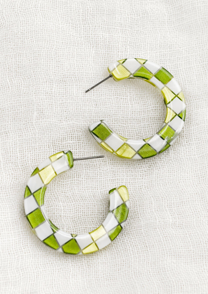 A pair of checkered earrings in green.