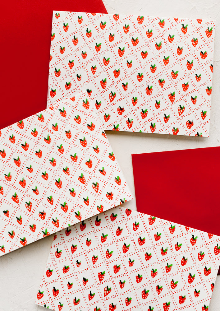 1: A boxed card set with quilted strawberry print.