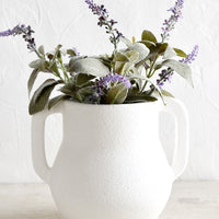 1: A matte white ceramic vase with lavender sprigs.