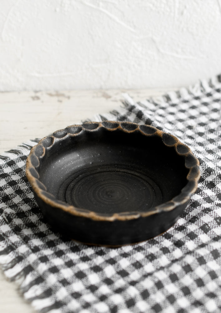Meteor Black: A small ceramic bowl with pinched rim in black glaze.
