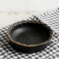 Meteor Black: A small ceramic bowl with pinched rim in black glaze.
