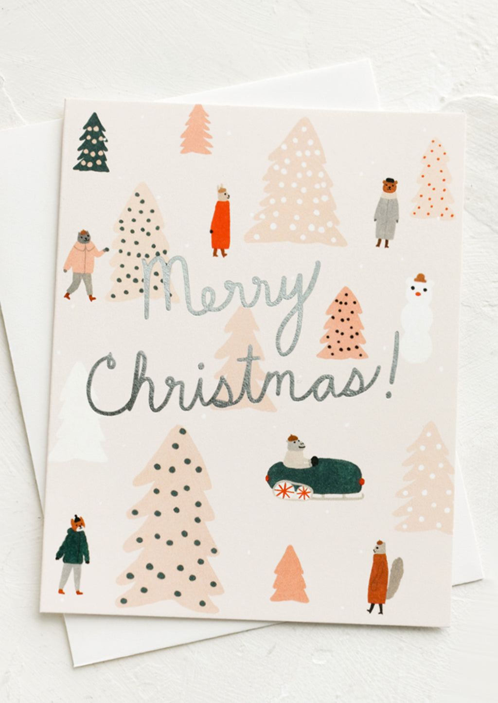 2: A greeting card with animals surrounded by pink Christmas trees and silver text reads "Merry Christmas!".