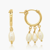 2: A pair of gold hoop earrings with three dangling pearls on each.