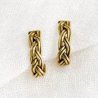 1: A pair of braided brass earrings that curve at bottom.