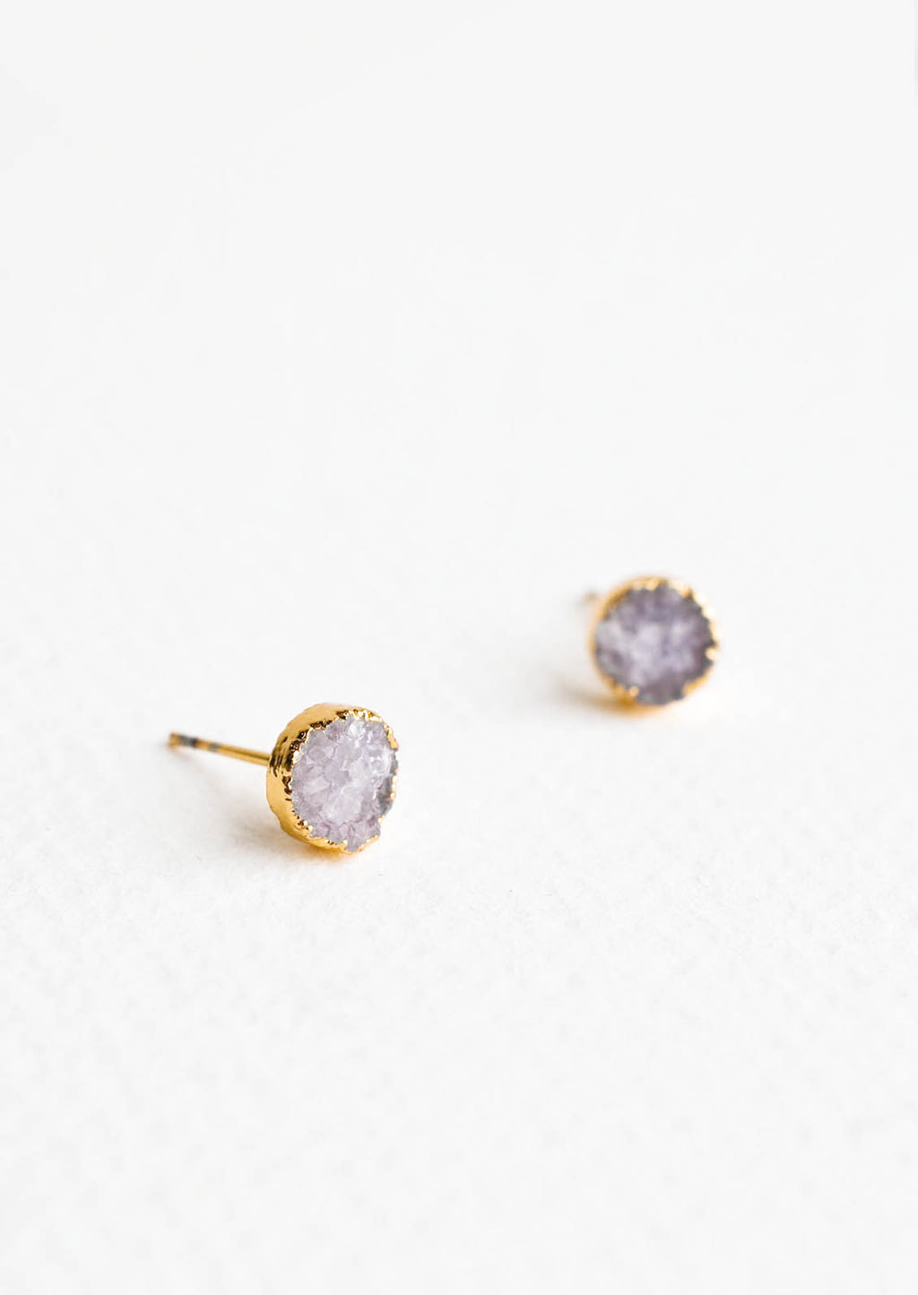 Mercury: Textured gray gemstone studs with gold surround.
