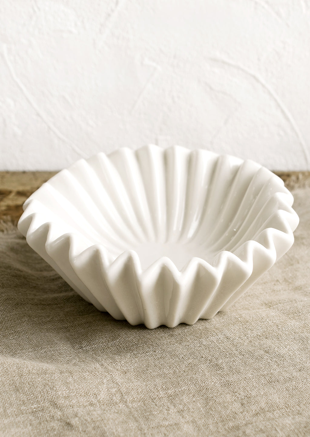 Large: A white bowl with folded/pleated design.