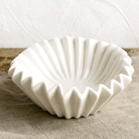Large: A white bowl with folded/pleated design.