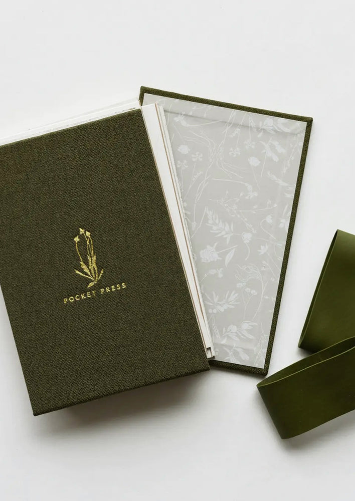 3: A green linen covered pocket-sized flower press booklet.