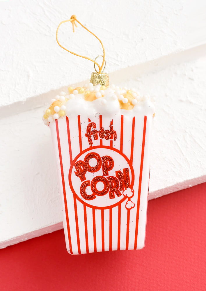 1: A glass ornament in shape of popcorn bag.
