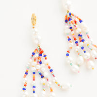 1: Earrings with multiple, heavily beaded dangling strands of large pearls mixed with small colorful beads