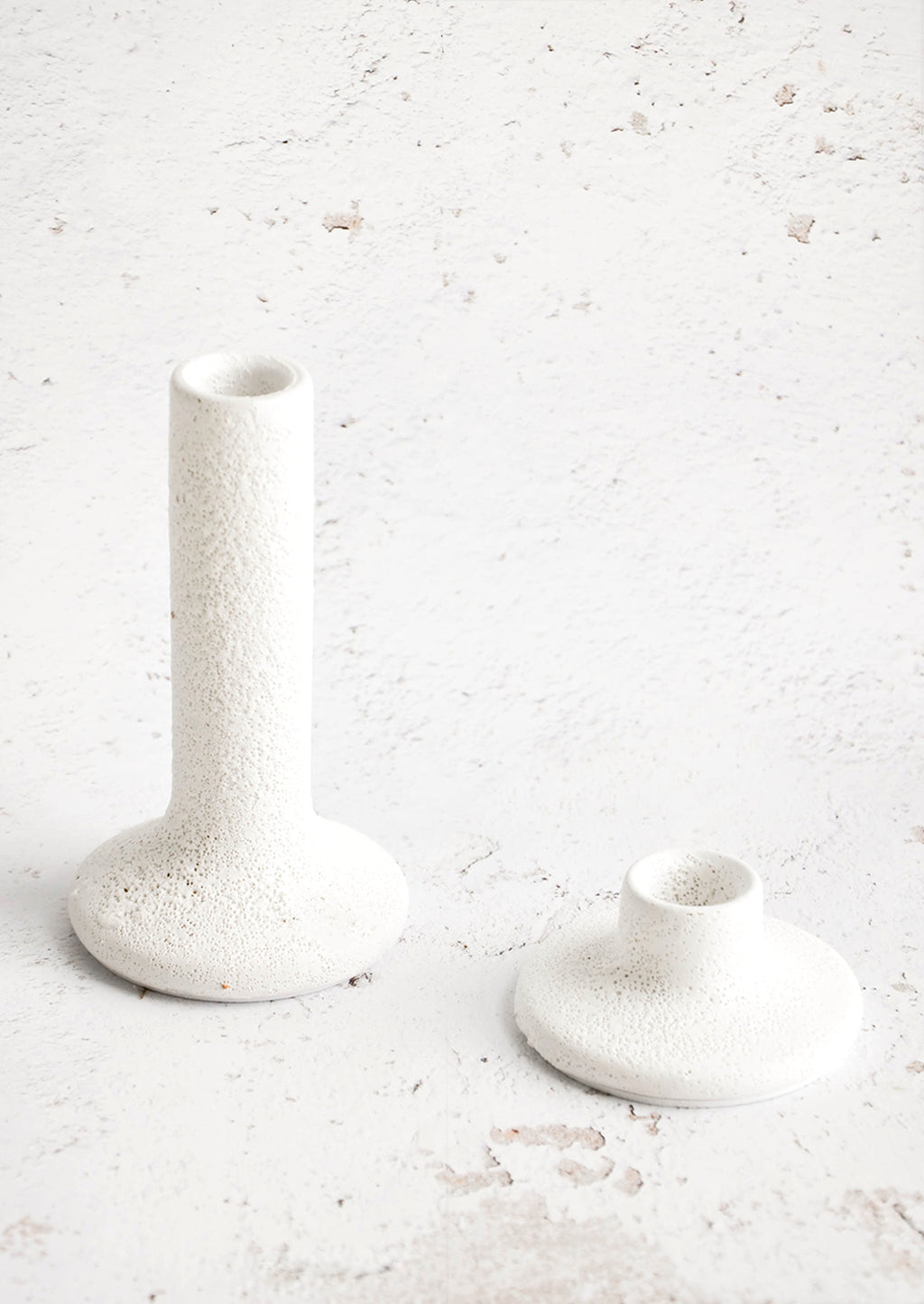 1: Taper candle holders in short and tall heights, made in rough textured white ceramic