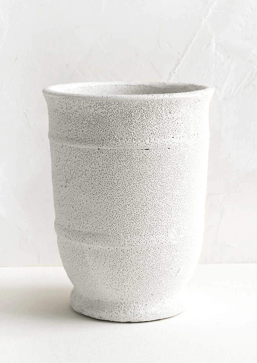 2: A tall planter in textured white glaze.