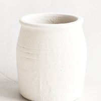 1: Crock-style utensil holder in ceramic with heavily textured, bubbly white glaze