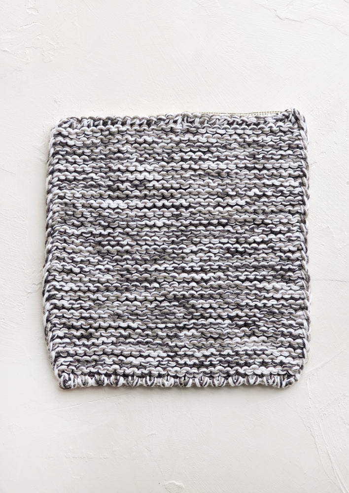 A square, chunky knit cotton potholder in black and white marl.