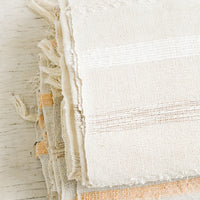 2: Folded gauze cotton blankets on a table.