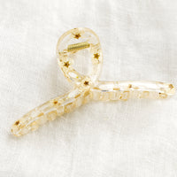 White: A clear crescent shaped hair claw with white dried flowers.