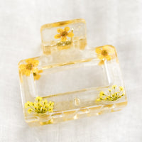 Yellow: A square hair claw in clear resin with yellow dried flowers.