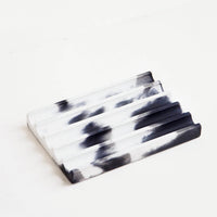 Black / White: A marbled black and white smooth concrete soap dish with troughs and ridges.