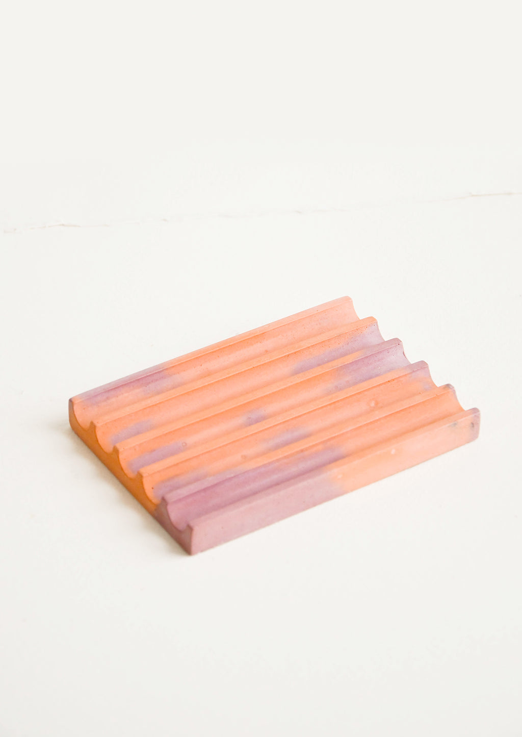 Coral / Mauve: A marbled coral and mauve smooth concrete soap dish with troughs and ridges.