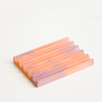 Coral / Mauve: A marbled coral and mauve smooth concrete soap dish with troughs and ridges.