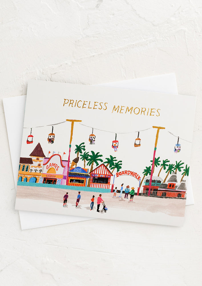 1: A card with illustration of carnival beachside scene reading "Priceless Memories".