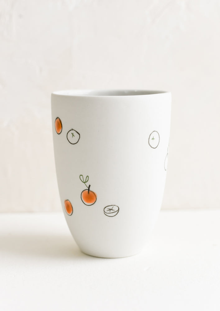 Large / Orange: A tall porcelain cup with hand drawn oranges.