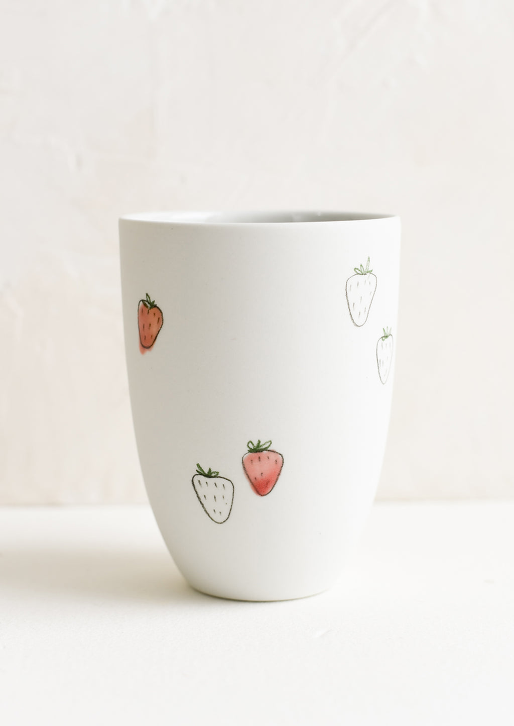 Large / Strawberry: A tall porcelain cup with hand drawn strawberries.
