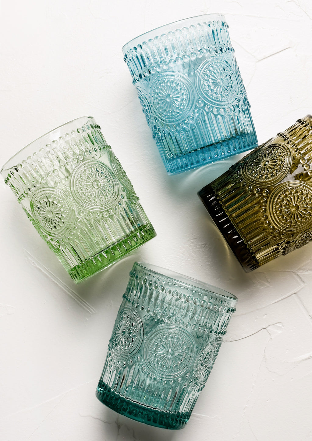 1: Glass cups in assorted blues and greens with Mexican inspired embossed medallion design.
