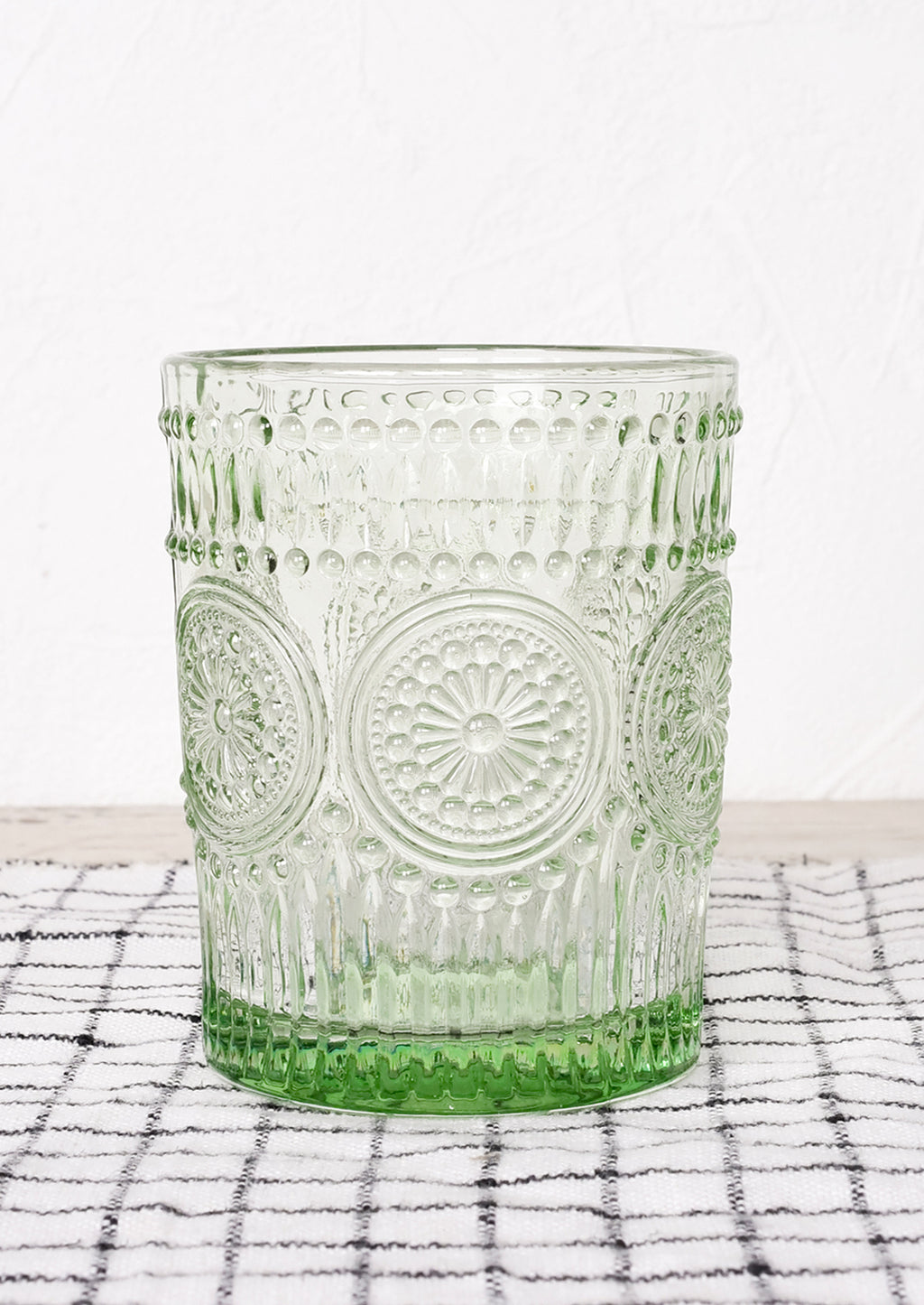 Bottle Green: A green glass cup in embossed design.