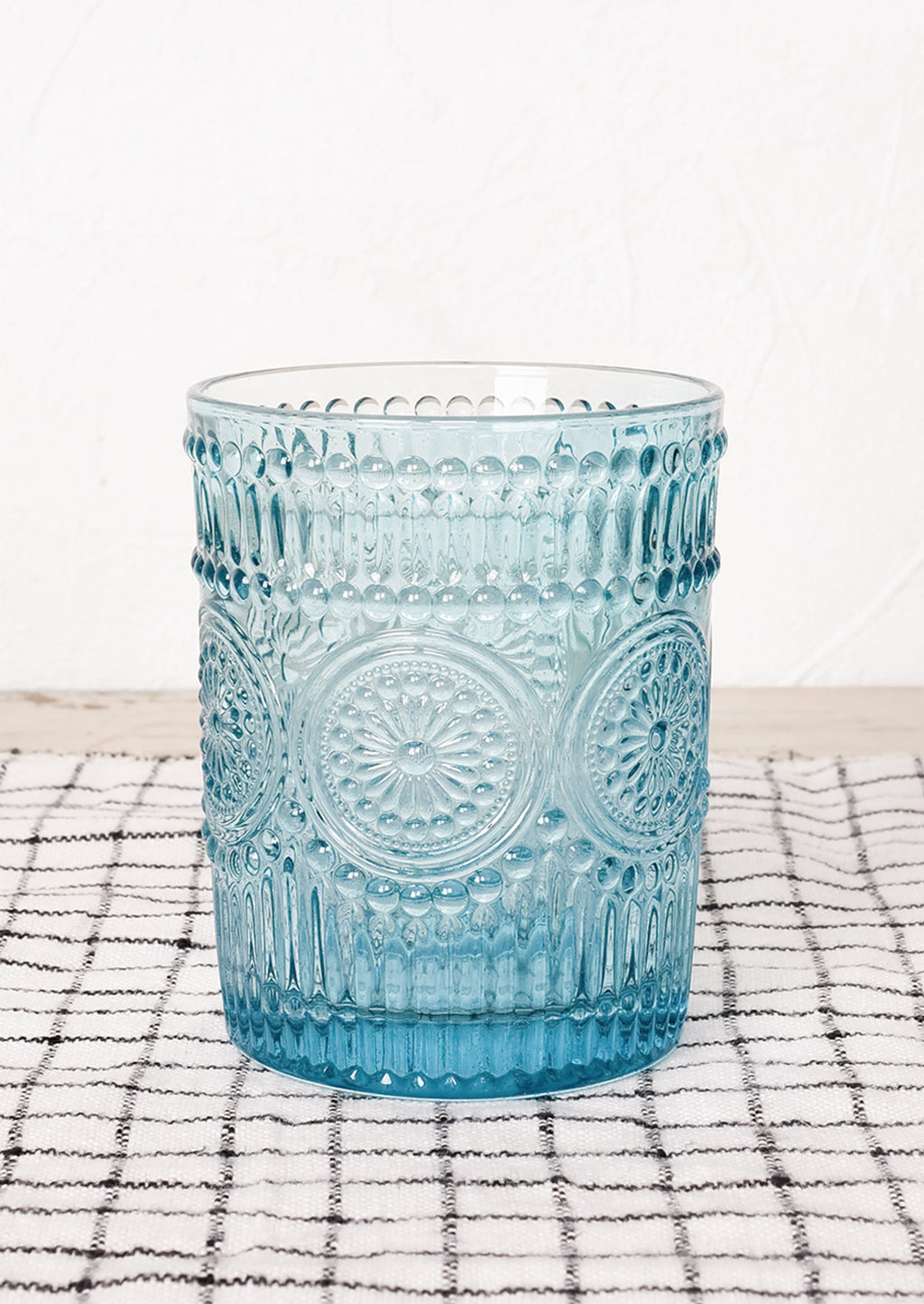Turquoise: A turquoise glass cup in embossed design.