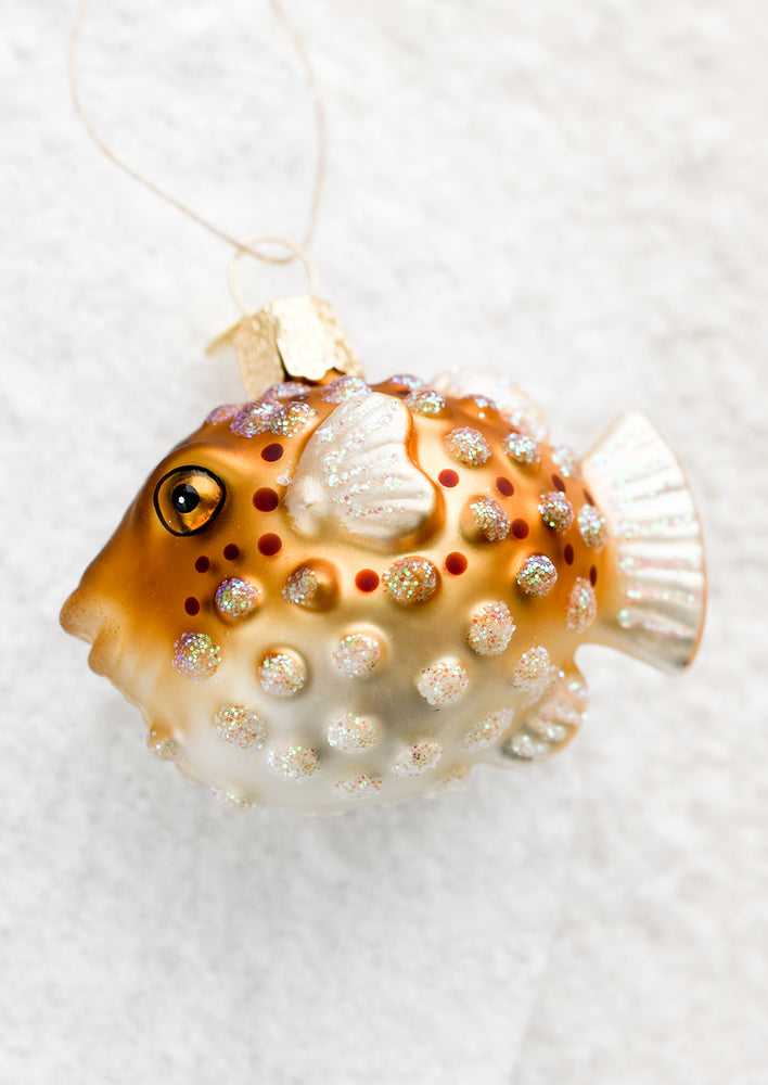 A glass holiday ornament of a pufferfish.
