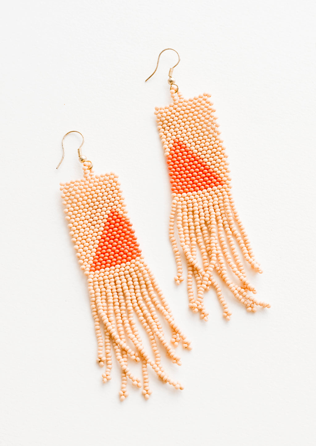 1: Long rectangular fringe beaded earrings in peach with orange triangle designs.