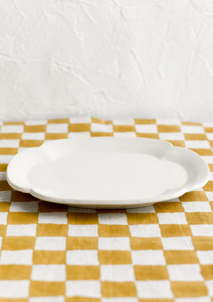 A quatrefoil shaped white ceramic platter/plate.