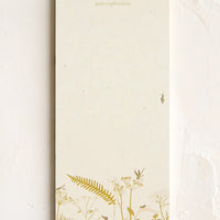 Quiet Explorations: A list making notepad with "quiet explorations" printed at top with a decorative botanical border.