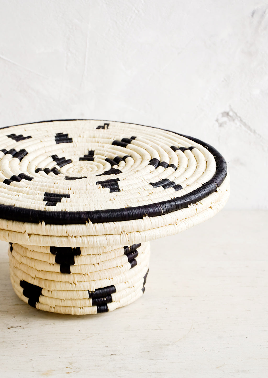 3: Round woven raffia cake stand in natural with black triangle print