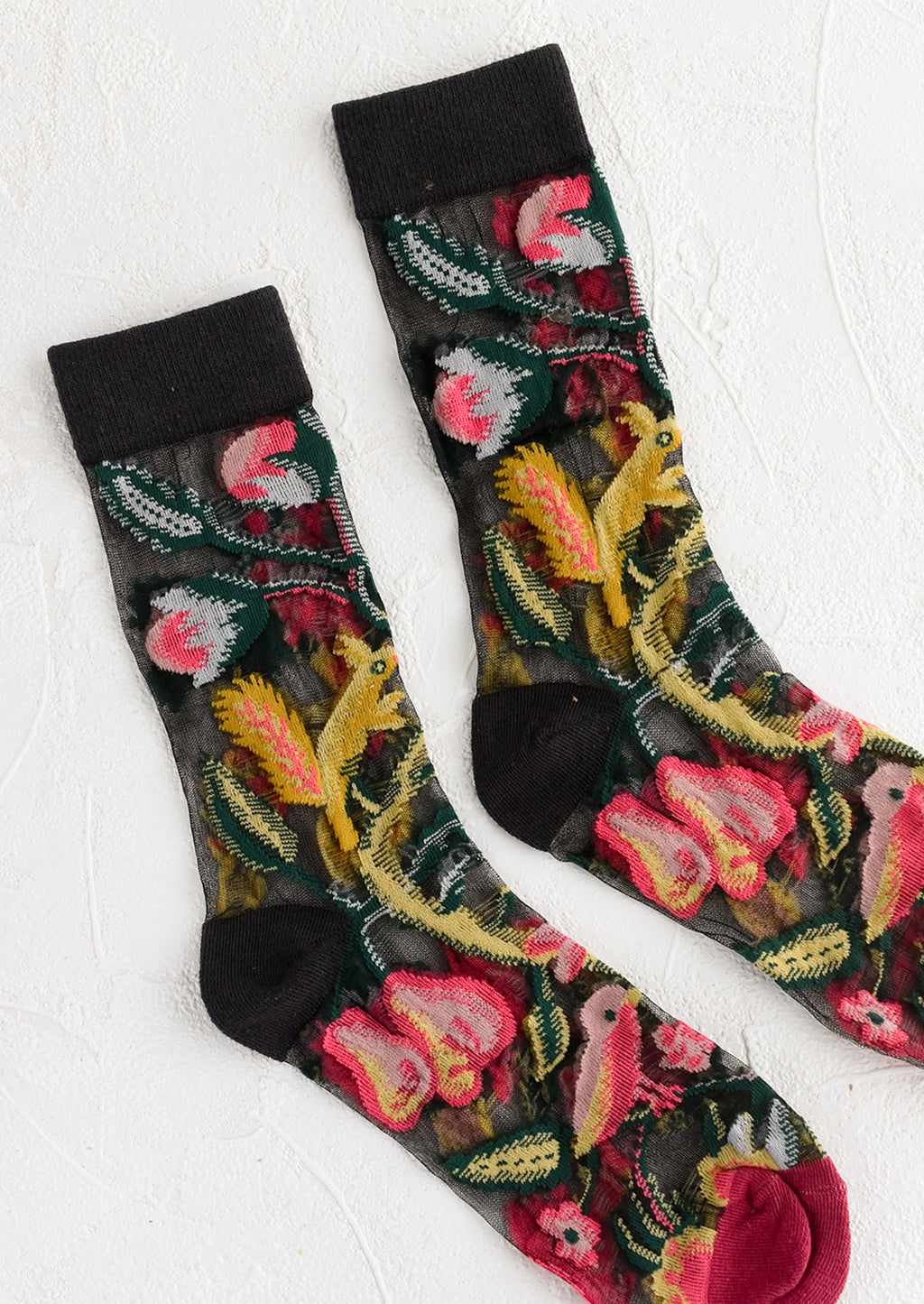 1: A pair of sheer black socks with multicolor creature print.